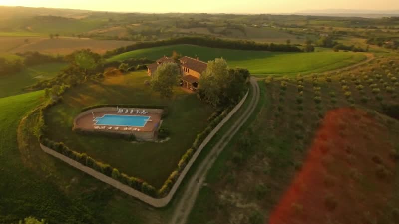 A newly built luxury home with a pool at golden hour